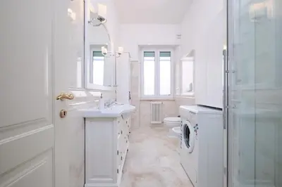 a white bathroom with a sink and a toilet at Residenza Lucis - Camillo Hospital - Monteverde by Hôtea in Rome
