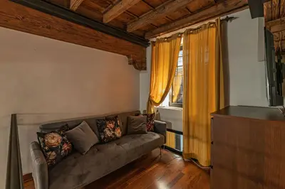 a living room with a couch and a window at Domus Campo de Fiori in Rome