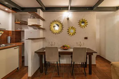 a kitchen with a dining room table and chairs at Domus Campo de Fiori in Rome