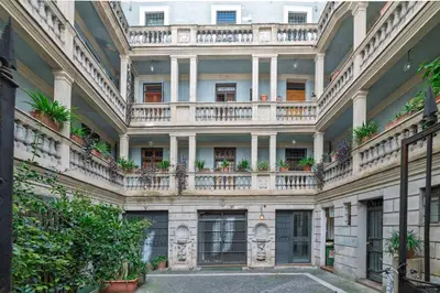 an old building with balconies and potted plants at Domus Campo de Fiori in Rome