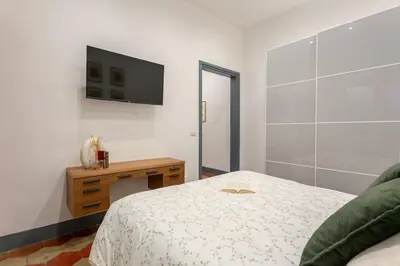 a bedroom with a bed and a television on the wall at MyRentalInn Scarlatti Rhome Parioli in Rome