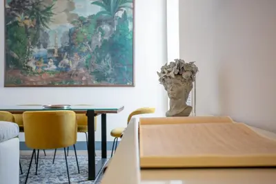 a dining room with a table and a vase at MyRentalInn Scarlatti Rhome Parioli in Rome