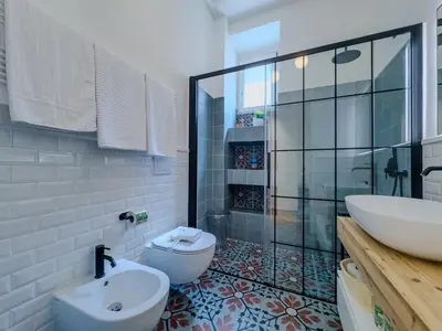 a bathroom with a shower and a toilet and a sink at Casa Alessandria in Rome