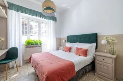 a bedroom with a large bed and a window at Next Stop Vatican Guest House in Rome