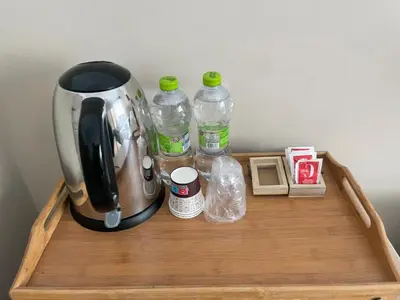a coffee maker and water bottles on a wooden tray at Next Stop Vatican Guest House in Rome
