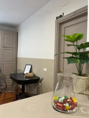 a vase filled with candy on top of a table at Next Stop Vatican Guest House in Rome