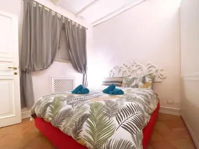 a bedroom with a large bed with blue pillows at Best Location in Rome -Historical Center in Rome