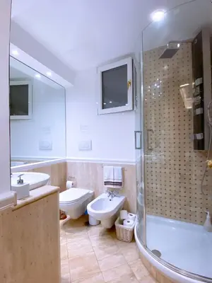 a bathroom with two sinks a toilet and a shower at Best Location in Rome -Historical Center in Rome