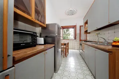 a kitchen with a sink and a microwave at Fossato Di Vico in Rome