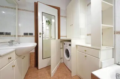 a bathroom with a sink and a washing machine at Fossato Di Vico in Rome