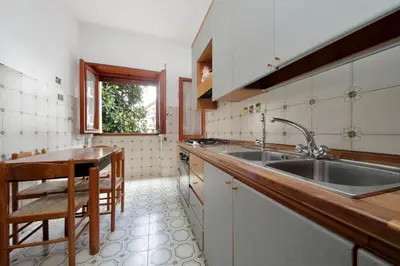 a kitchen with a sink and a table in it at Fossato Di Vico in Rome