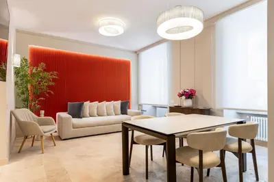 a living room with a table and chairs and a couch at Petra Apartments San Giovanni in Rome