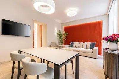 a living room with a table and a couch at Petra Apartments San Giovanni in Rome