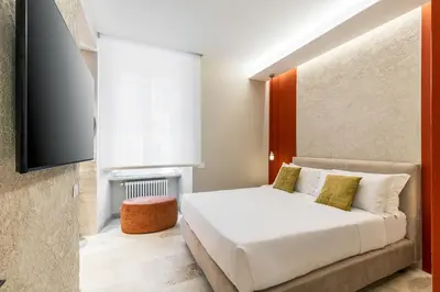 a bedroom with a bed and a tv at Petra Apartments San Giovanni in Rome