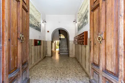 a hallway with wooden doors and a staircase at Petra Apartments San Giovanni in Rome