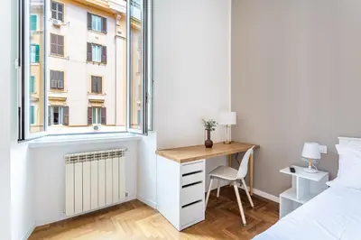 a bedroom with a desk and a bed and a window at iFlat New Refined Apartment Near the Vatican in Rome