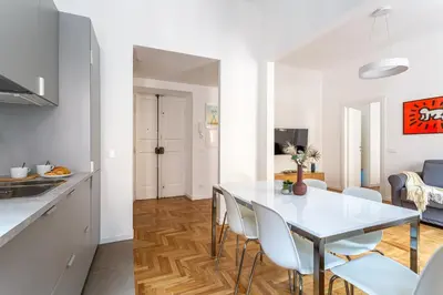 a kitchen and dining room with a white table and chairs at iFlat New Refined Apartment Near the Vatican in Rome
