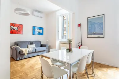 a living room with a white table and chairs at iFlat New Refined Apartment Near the Vatican in Rome