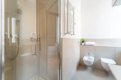 a bathroom with a shower and a toilet and a sink at iFlat New Refined Apartment Near the Vatican in Rome