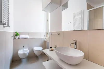 a white bathroom with a sink and a toilet at iFlat New Refined Apartment Near the Vatican in Rome