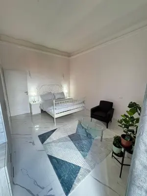 a living room with a bed and a black chair at BANGA HOUSe in Rome