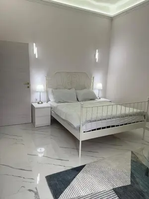a white bedroom with a large bed with two lamps at BANGA HOUSe in Rome
