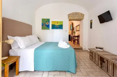 a bedroom with a bed with a blue table at San Lorenzo Studio Flat in Rome