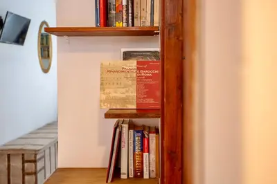 a book shelf with many books on it at San Lorenzo Studio Flat in Rome