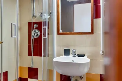 a bathroom with a sink and a shower at San Lorenzo Studio Flat in Rome