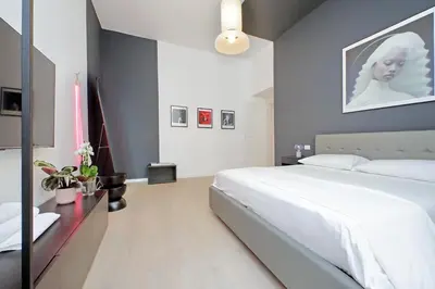 a bedroom with a large white bed in a room at Elegance in Parioli Rome La casa di Pigi in Rome