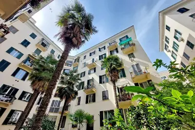 a group of palm trees in front of a building at Elegance in Parioli Rome La casa di Pigi in Rome