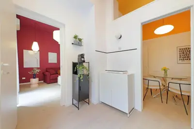 a living room with a table and a red couch at Elegance in Parioli Rome La casa di Pigi in Rome