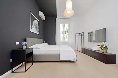 a bedroom with a bed and a television in it at Elegance in Parioli Rome La casa di Pigi in Rome