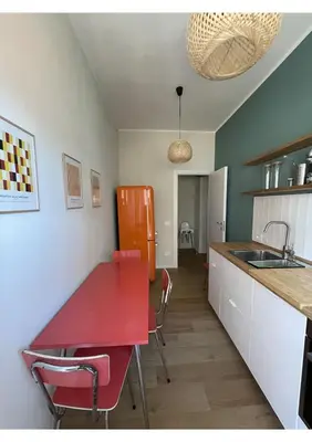a kitchen with a red table and a red refrigerator at Bonci Rooms - Appartamento in zona Policlinico Gemelli, Università Cattolica, Vaticano, Stadio Olimpico in Rome