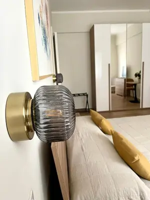 a lamp on the side of a bed in a room at Bonci Rooms - Appartamento in zona Policlinico Gemelli, Università Cattolica, Vaticano, Stadio Olimpico in Rome