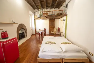 a bedroom with a large bed in a room at Trastevere Romantic Nest in Rome