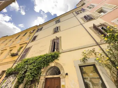 a building with a door and ivy at Trastevere Romantic Nest in Rome