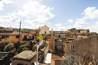 a view of a city from the roof of a building at Trastevere Romantic Nest in Rome