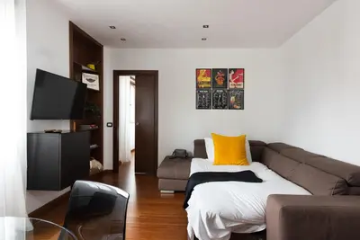 a living room with a couch and a tv at Vatican Loft - Mura Vaticane in Rome