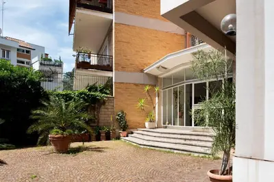 a building with stairs and plants in front of it at Vatican Loft - Mura Vaticane in Rome