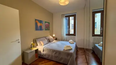 a bedroom with a bed with two towels on it at Elegant Roman Escape Walk to the Colosseum in Rome