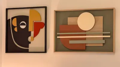 two pieces of art hanging on a wall at Elegant Roman Escape Walk to the Colosseum in Rome