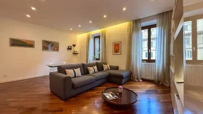 a living room with a couch and a table at Elegant Roman Escape Walk to the Colosseum in Rome
