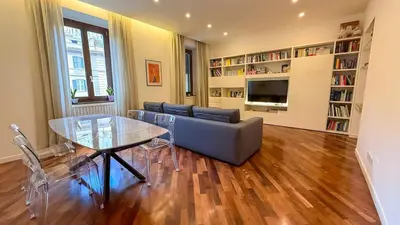 a living room with a couch and a glass table at Elegant Roman Escape Walk to the Colosseum in Rome