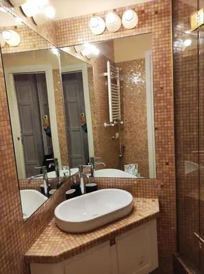a bathroom with two sinks and a large mirror at Library's House in Rome