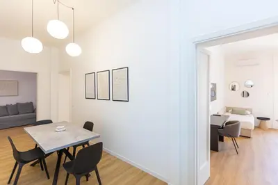 a living room and dining room with a table and chairs at Constance Apartment by Rental in Rome in Rome