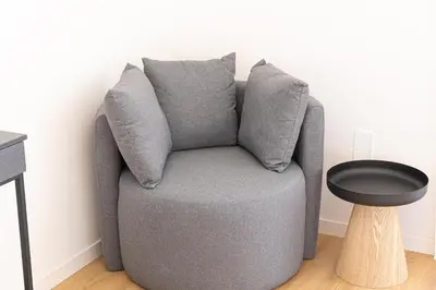 a grey chair in a room with a table at Constance Apartment by Rental in Rome in Rome