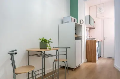 a small kitchen with a small table and stools at City Comfort - 20 minutes walk to the Colosseum in Rome