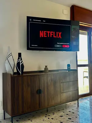 a television on a wall with a netflix sign on it at Casa Conce two metro stops from the colosseum in Rome