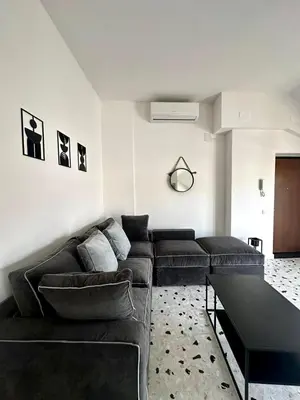 a living room with a couch and a table at Casa Conce two metro stops from the colosseum in Rome